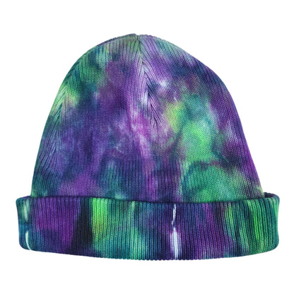 Tie-dye knit beanie hat in purple, green, and teal with ribbed cuff