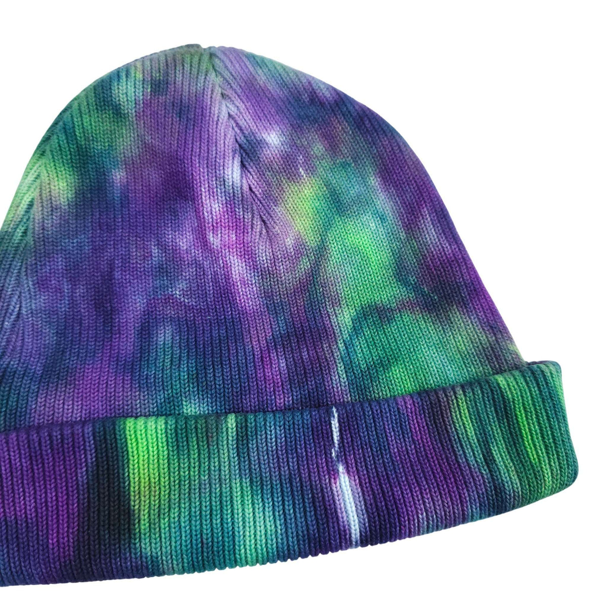 Tie-dye knit beanie hat with ribbed cuff and purple–green–teal pattern