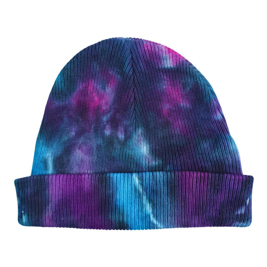 Nebula tie-dye beanie hat in blue, purple, and pink knit with a folded cuff