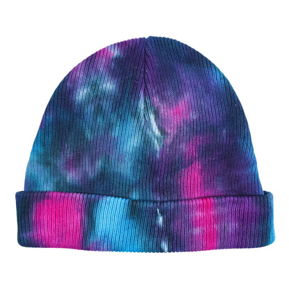 Tie-dye beanie hat with folded cuff, blue-to-purple pattern with pink highlights