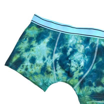 Blue-green tie-dye boxer briefs, side view with elastic waistband and pouch seam