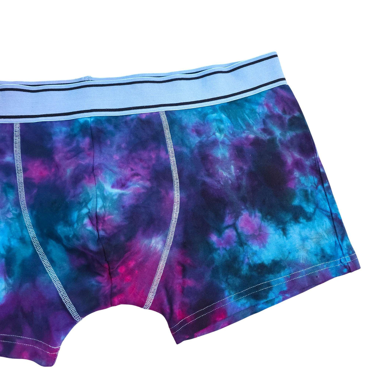 Men's tie-dye boxer briefs close-up: blue and purple nebula print, contrast stitching.
