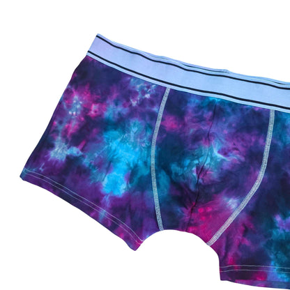 Men's tie-dye boxer briefs flat view, blue and purple nebula pattern with light-blue waistband.