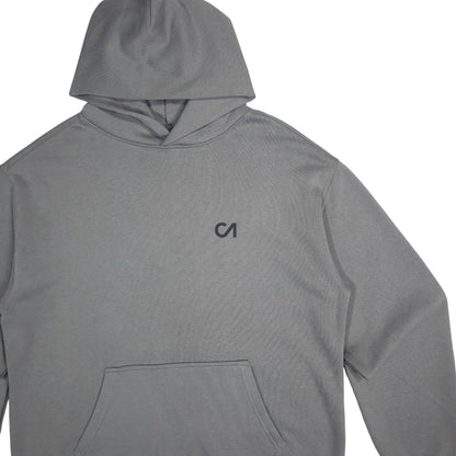 Grey pullover hoodie with hood and small chest logo, close view