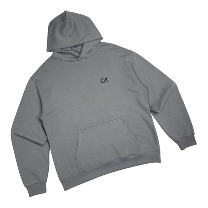 Grey pullover hoodie with kangaroo pocket and chest logo, tilted view