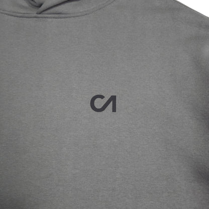 Grey hoodie fabric close-up with small chest logo