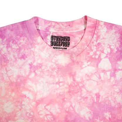 Pink tie-dye T-shirt close-up of crew neck and chest graphic logo; short sleeves.