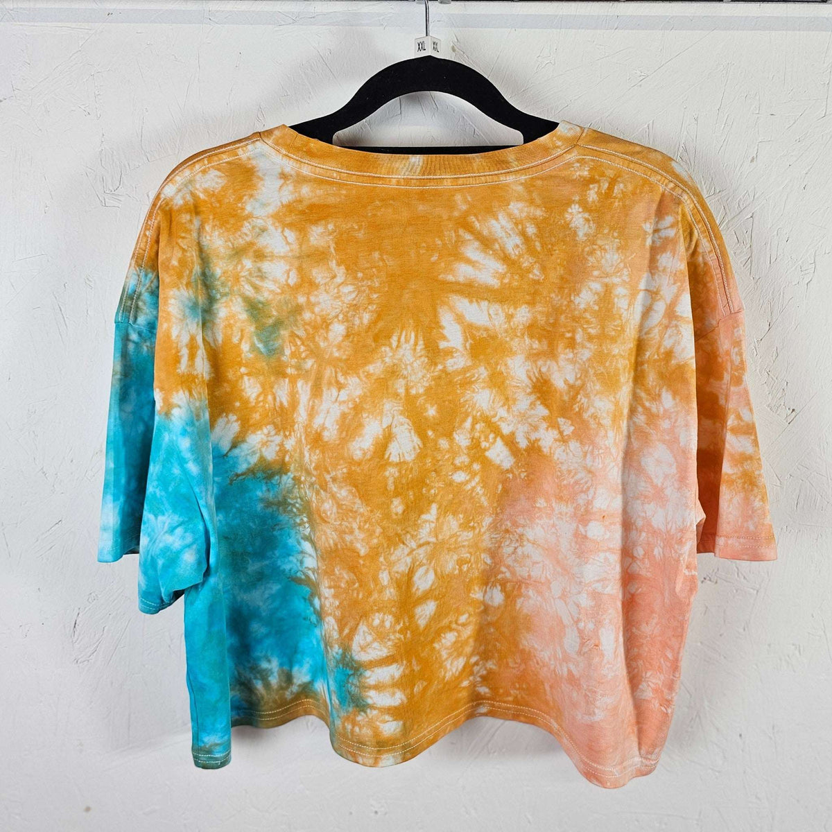 Back view: orange, peach & blue tie-dye crop top, short sleeves, crew neck.