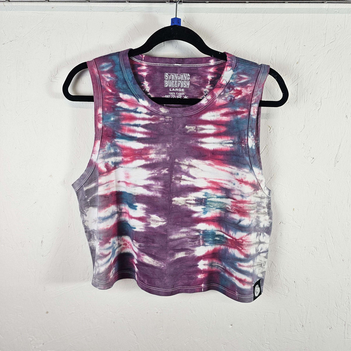 Sleeveless tie-dye crop vest with purple, pink, and blue swirl pattern