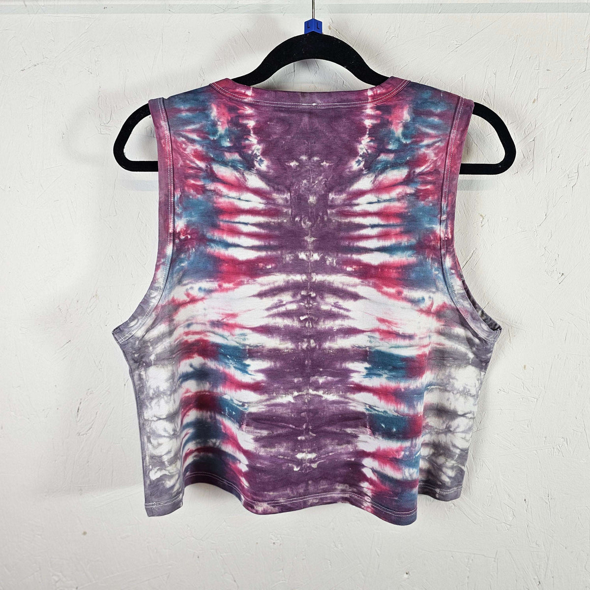 Sleeveless tie-dye crop vest with radial purple center and red, white, blue streaks