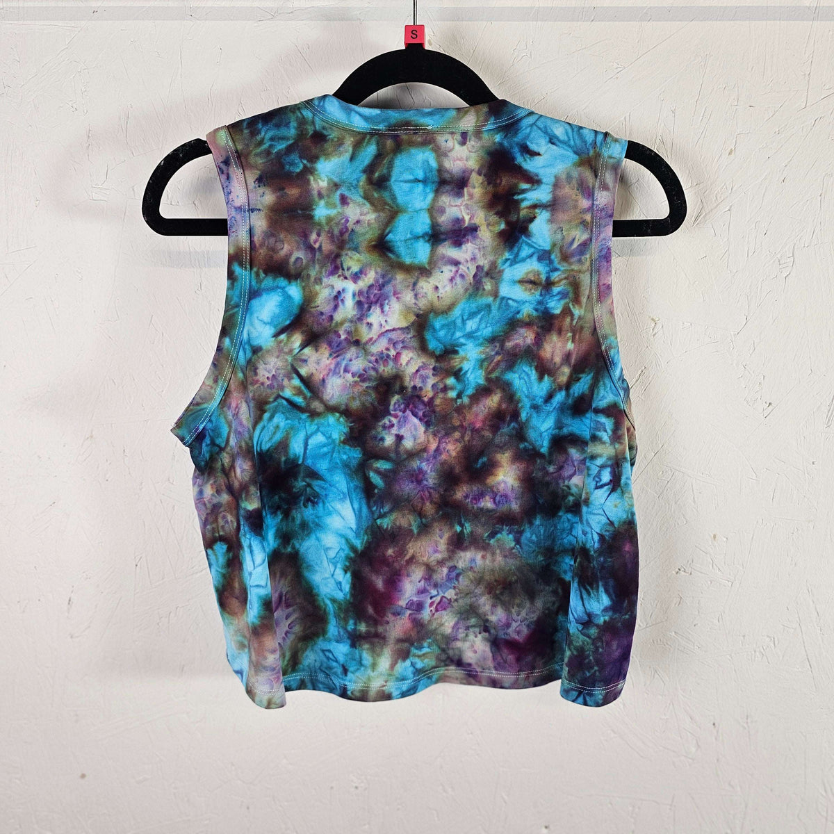 Tie-dye crop vest with sleeveless arms, teal and purple swirl pattern front