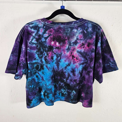 Back view of purple and blue tie-dye crop top with short sleeves and crew neck