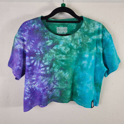 Tie-dye crop top with teal, green, and purple swirl pattern; short sleeves, crew neck.