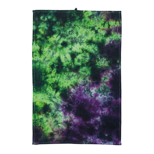 Tie-dye tea towel with green and purple swirls and dark stitched border
