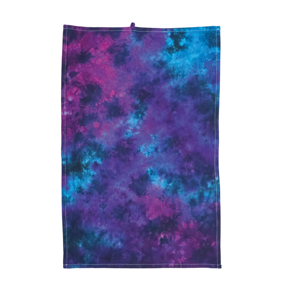 Nebula tie-dye tea towel in purple and blue with stitched edges and hanging loop