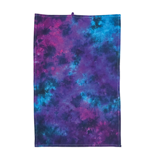 Nebula tie-dye tea towel in purple and blue with stitched edges and hanging loop