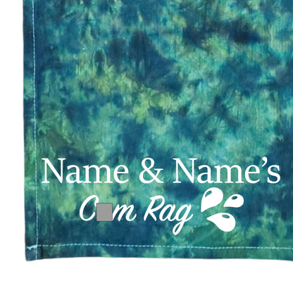 Tie-dye cloth in dark teal, green, and purple with printed 'Name & Name's' logo
